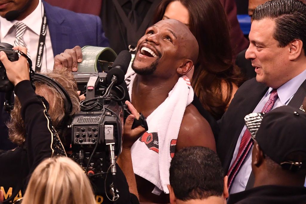 LAS VEGAS NV AUGUST 26 Floyd Mayweather Jr. reacts after defeating Conor McGregor in their super welterweight boxing...