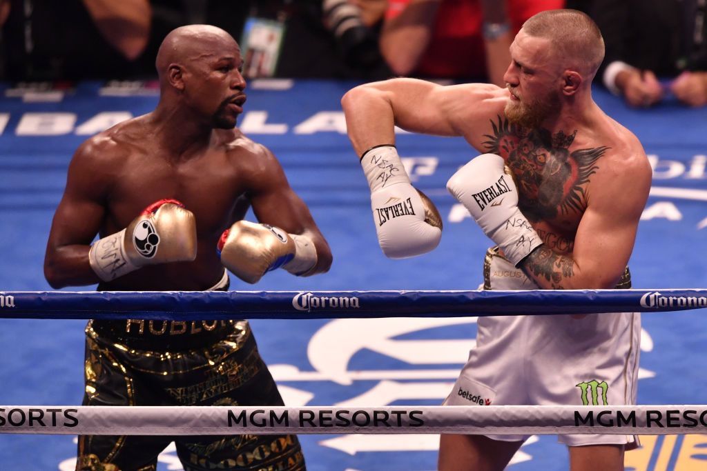 LAS VEGAS NV AUGUST 26 Floyd Mayweather Jr. and Conor McGregor exchange punches in their super welterweight boxing...