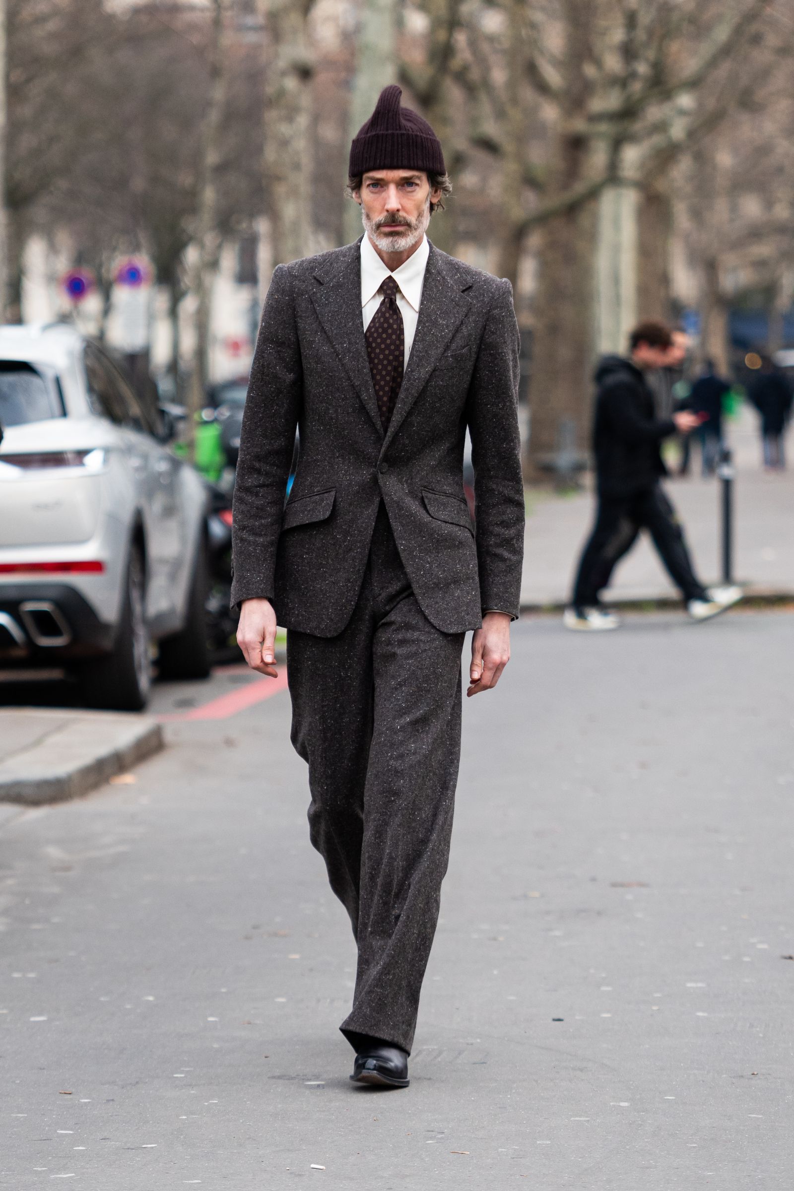 PARIS FRANCE JANUARY 19 Richard Biedul wears a dark grey suit and brown hat outside Issey Miyake during Paris Fashion...