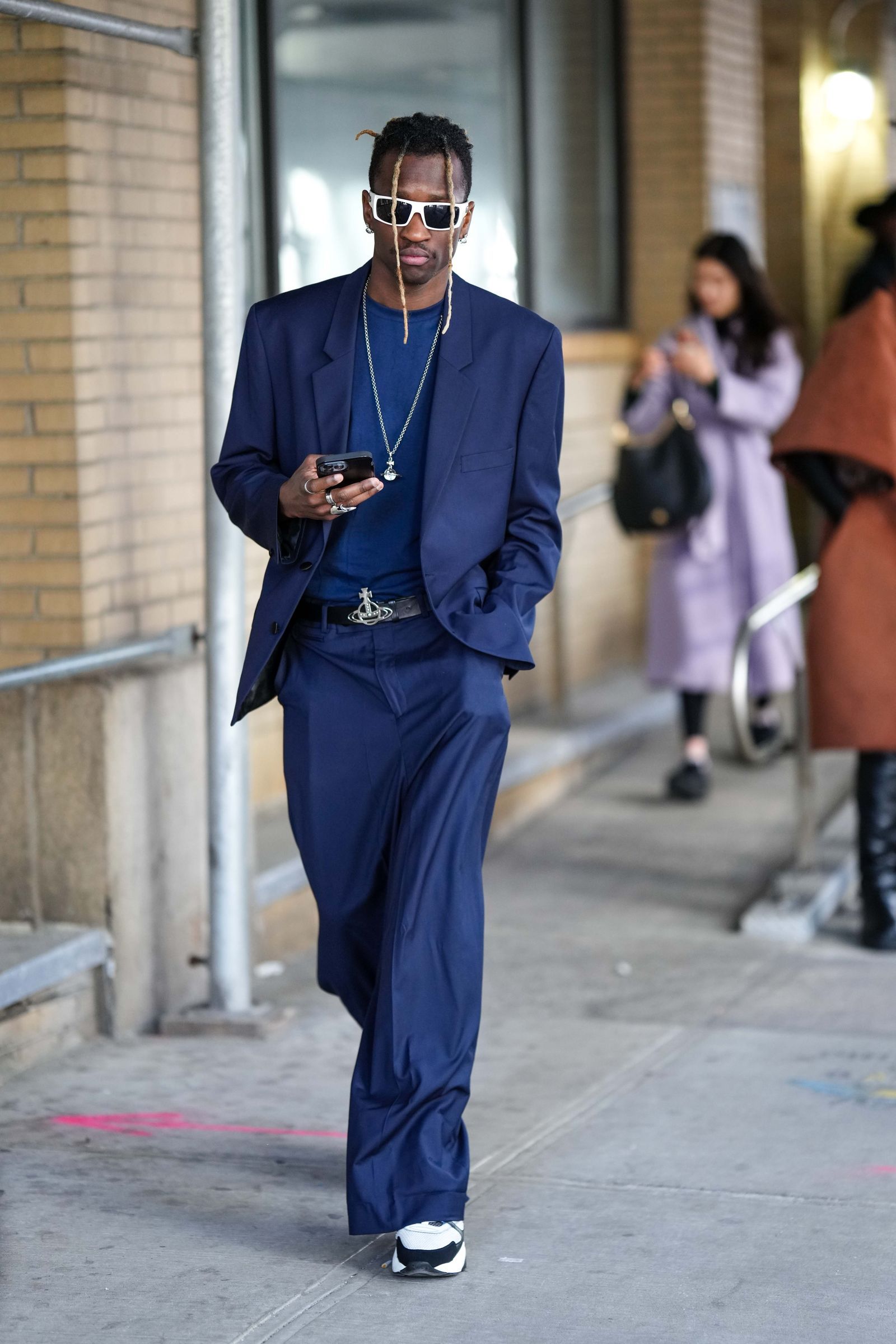 NEW YORK NEW YORK FEBRUARY 10 A guest wears white sunglasses a navy blue tshirt a navy blue blazer jacket matching navy...