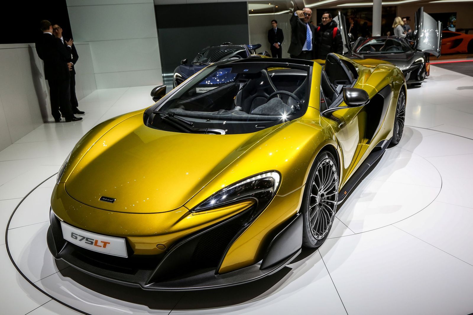 Image may contain Vehicle Transportation Automobile Car Human Person Sports Car Car Show Wheel and Machine