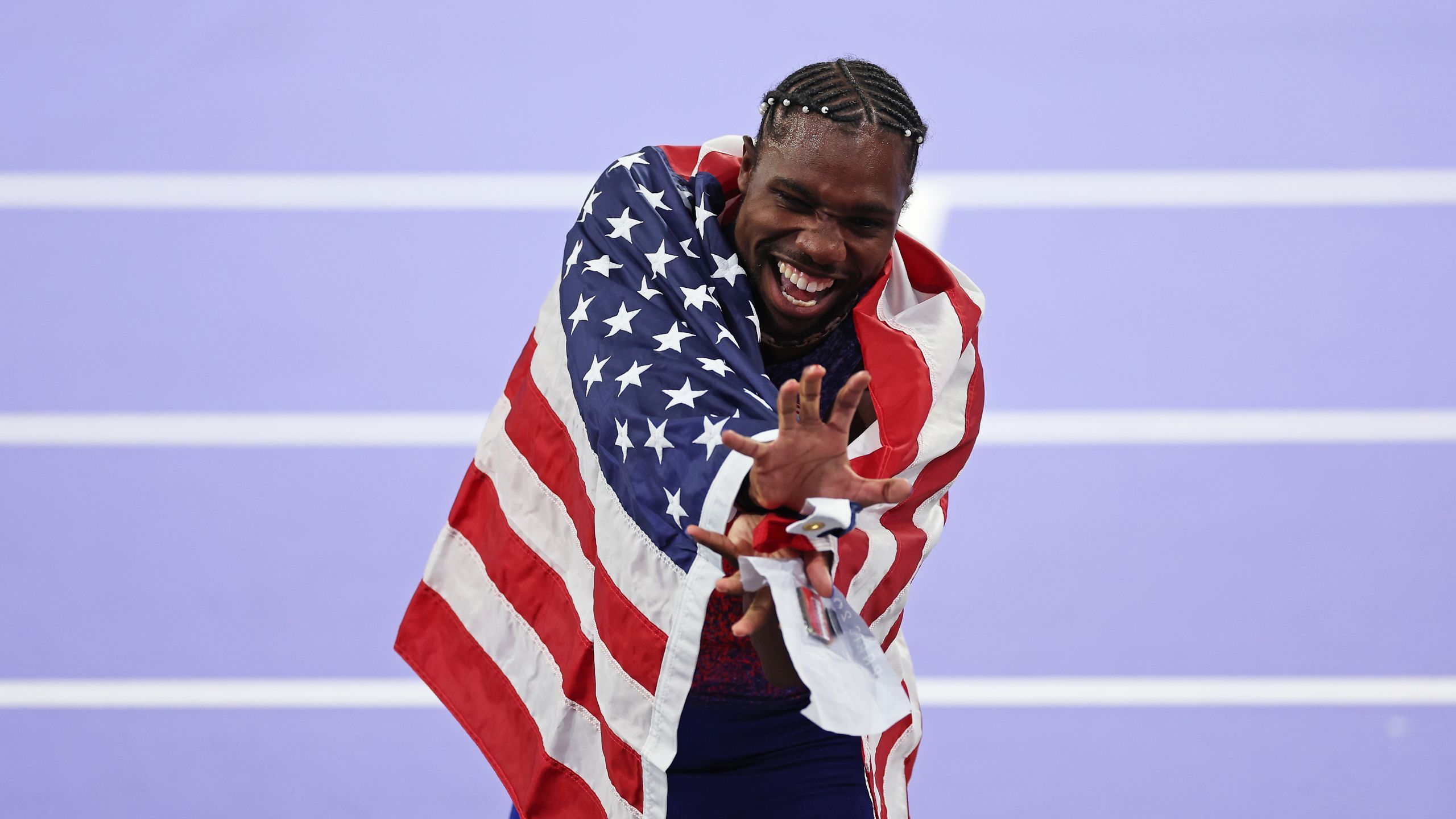PARIS FRANCE AUGUST 04 Noah Lyles of Team United States celebrates winning the gold medal in the Men's 100m Final on...