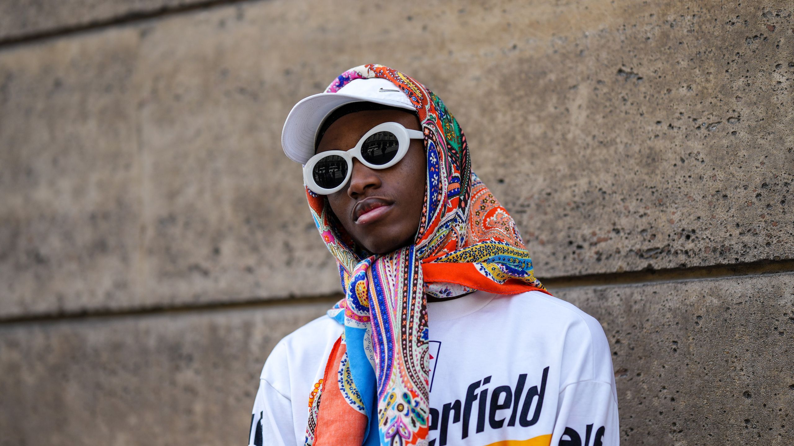 PARIS FRANCE JUNE 26 A guest wears a white cap white sunglasses a multicolored print pattern scarf a white with red and...
