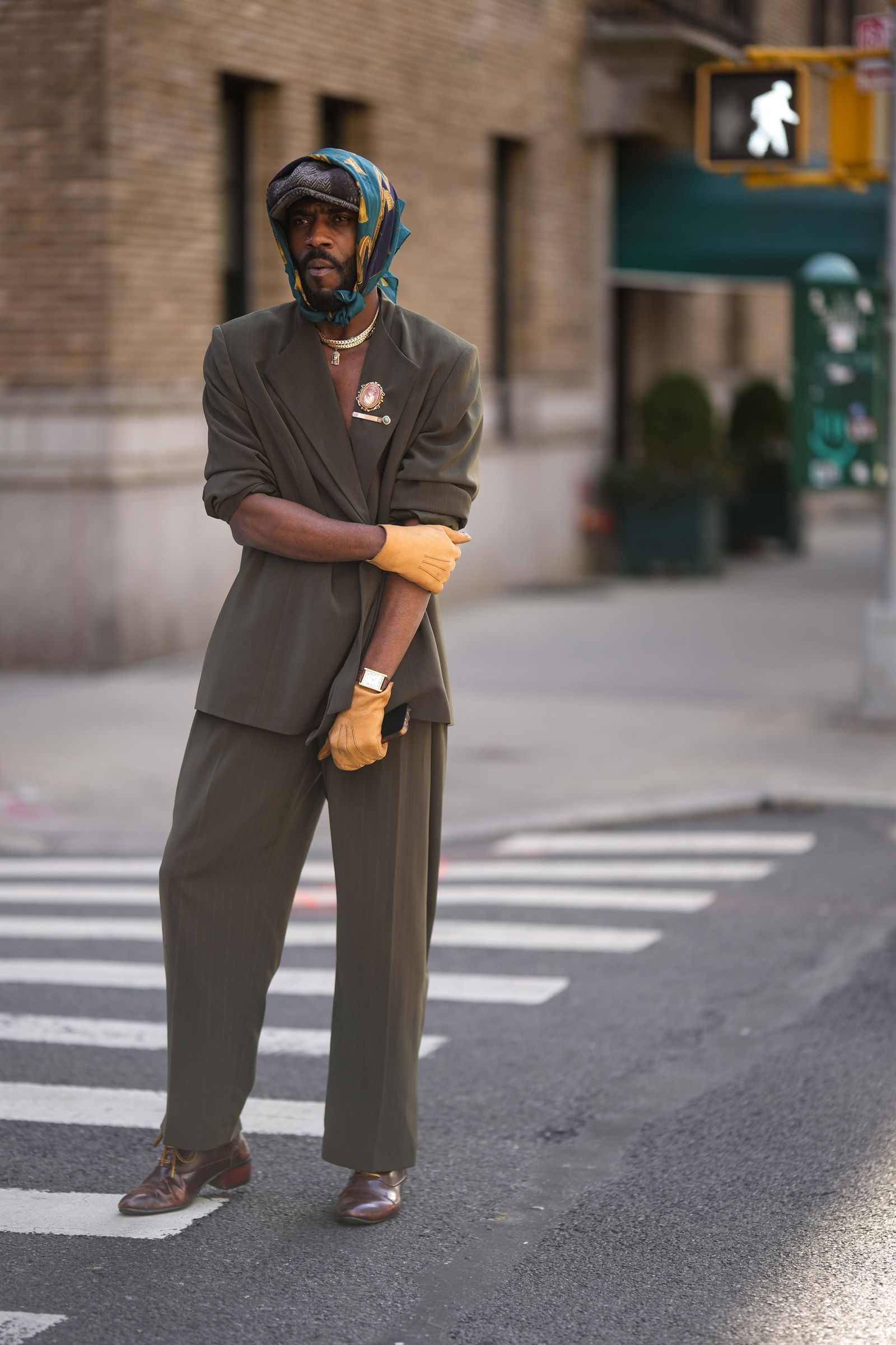 NEW YORK NEW YORK FEBRUARY 13 A guest wears a brown and beige striped print pattern wool beret a green and yellow print...