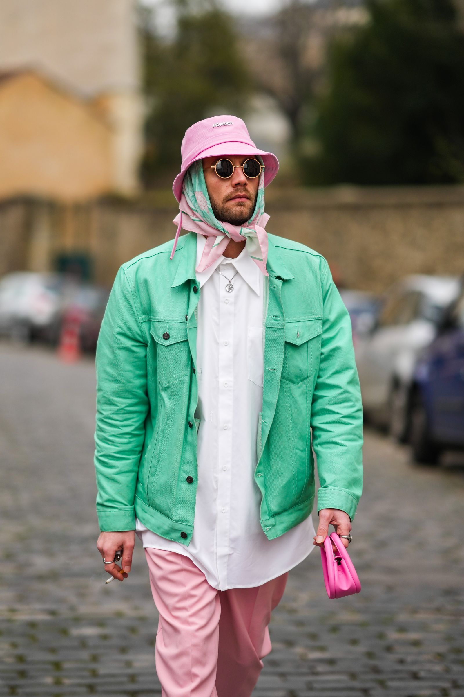 PARIS FRANCE JANUARY 22 Influencer Karb wears a pale pink bob from Jacquemus gold sunglasses a pale green and pink...