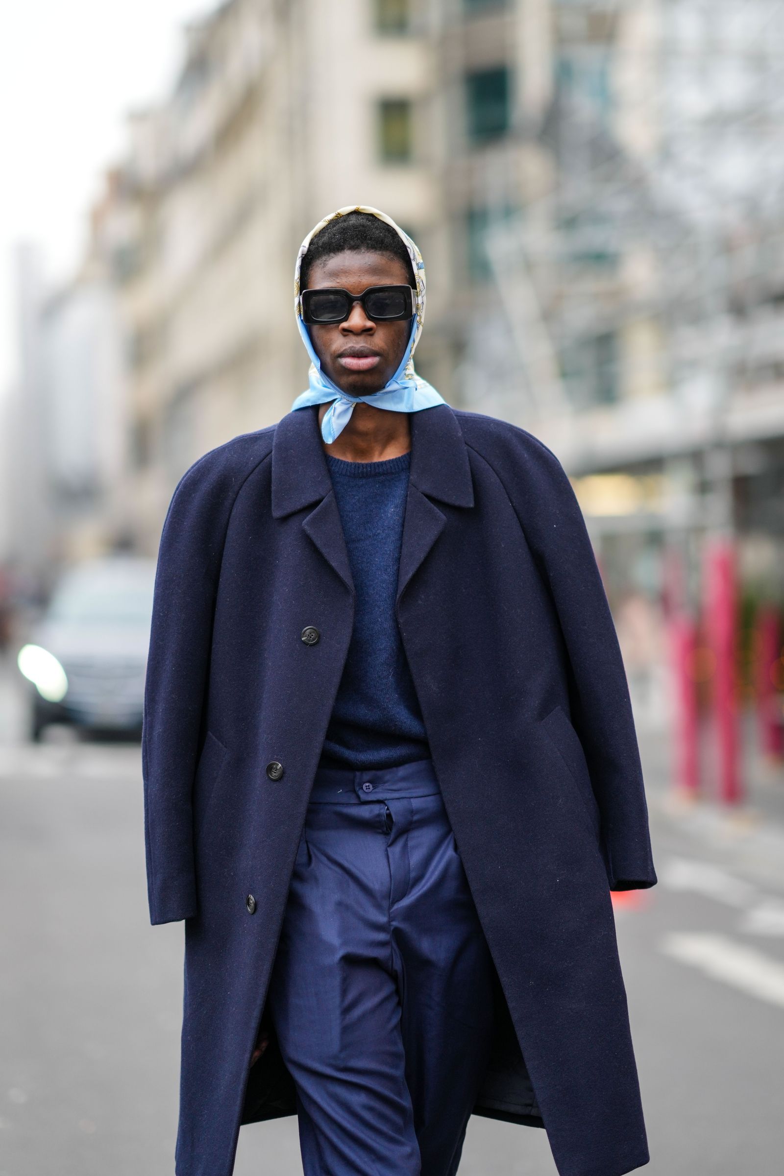 PARIS FRANCE JANUARY 27 A guest wears a pale blue with gold and white print pattern silk scarf black sunglasses a navy...