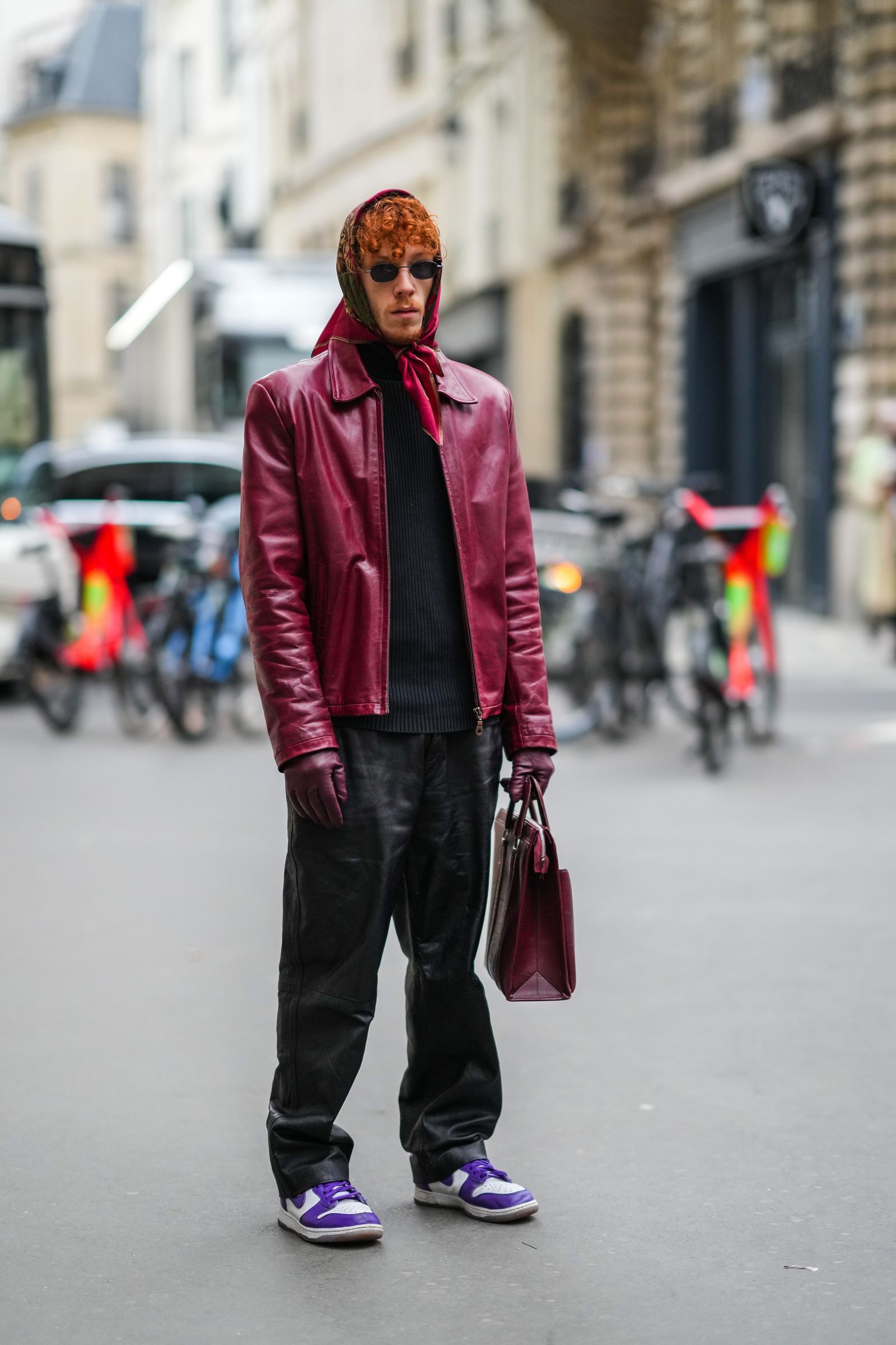 PARIS FRANCE JANUARY 23 A guest wears a burgundy brown khaki flower print pattern scarf black sunglasses a black...
