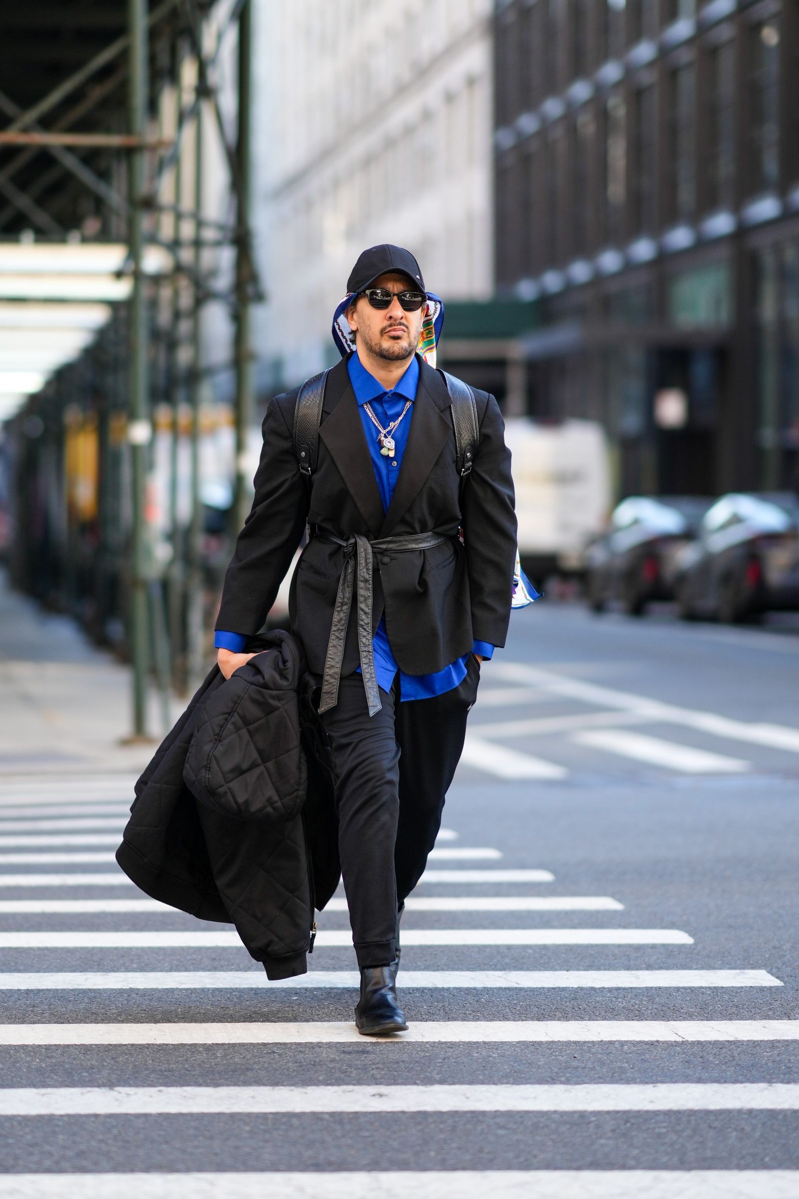 NEW YORK NEW YORK FEBRUARY 11 A guest wears a black cap a navy blue gold green red white print pattern silk scarf...