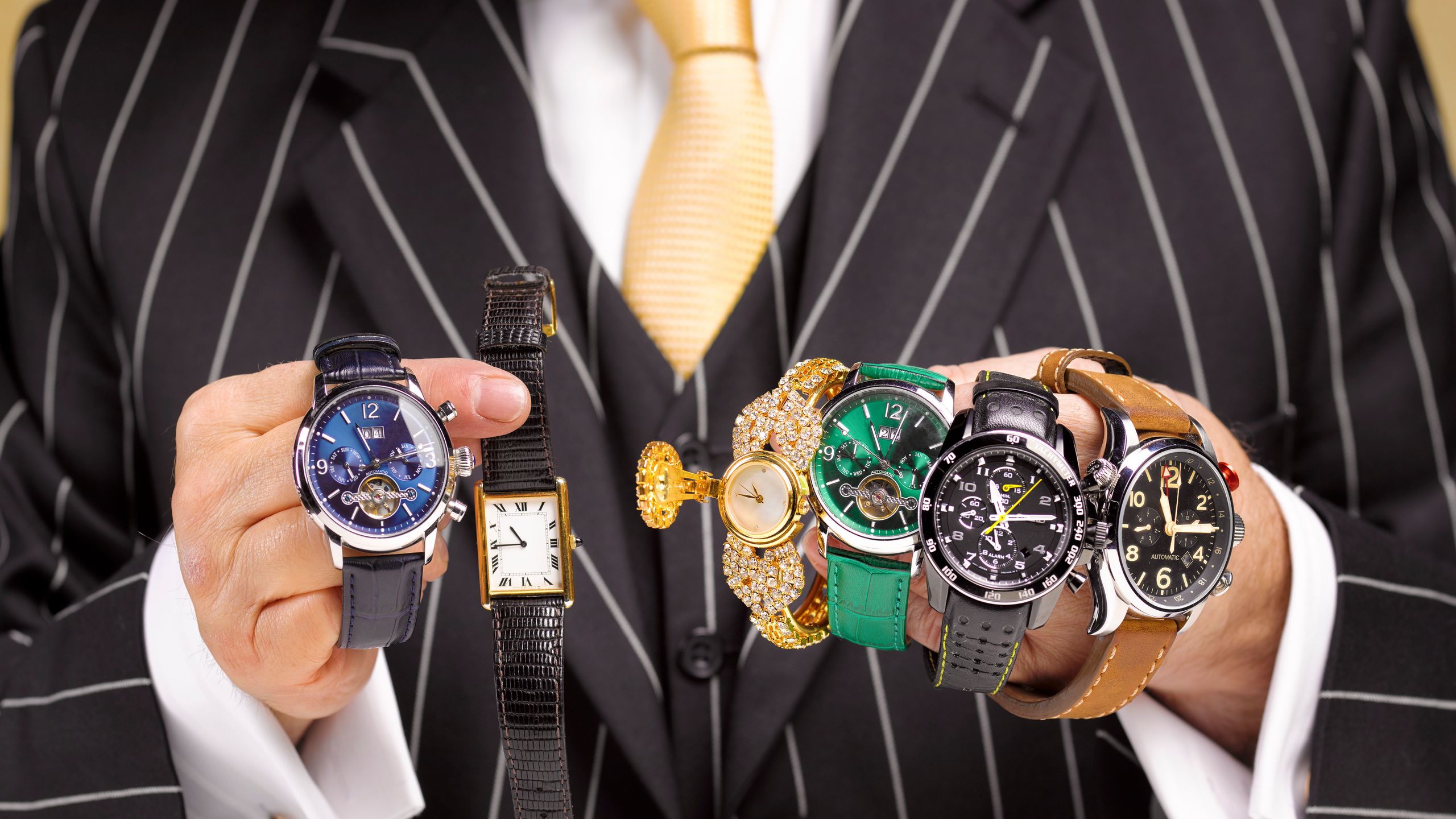 Close up of a black market trader's hands with a collection of watches.
