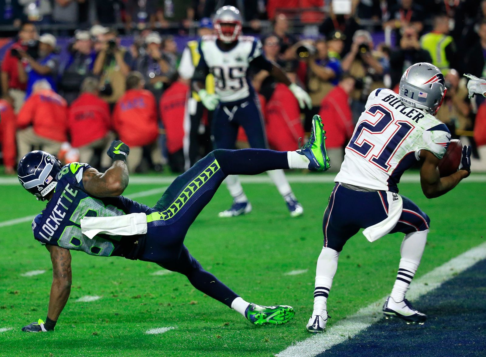 GLENDALE AZ FEBRUARY 01 Malcolm Butler 21 of the New England Patriots intercepts a pass by Russell Wilson 3 of the...