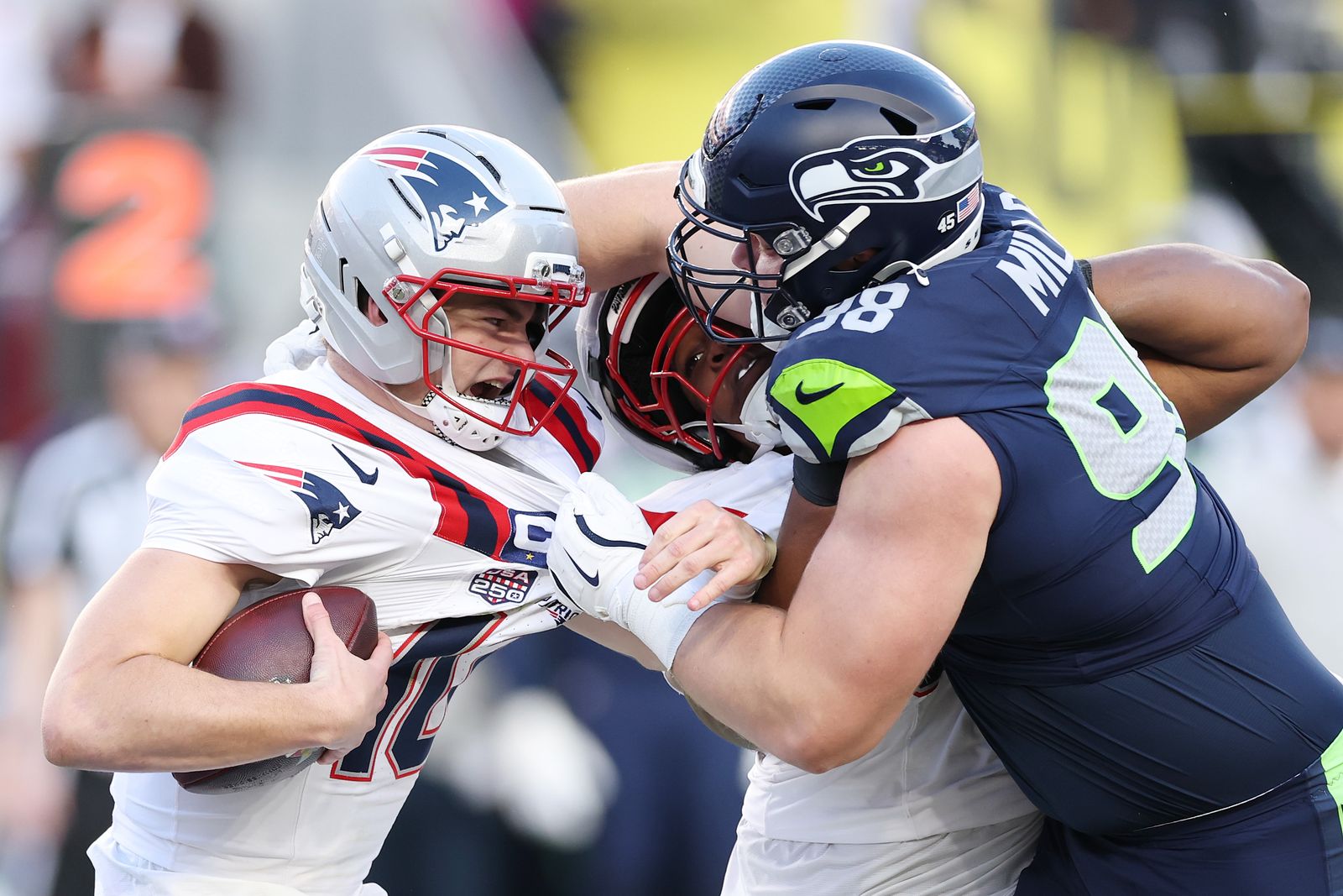 SANTA CLARA CALIFORNIA FEBRUARY 08 Drake Maye 10 of the New England Patriots is sacked by Rylie Mills 98 of the Seattle...