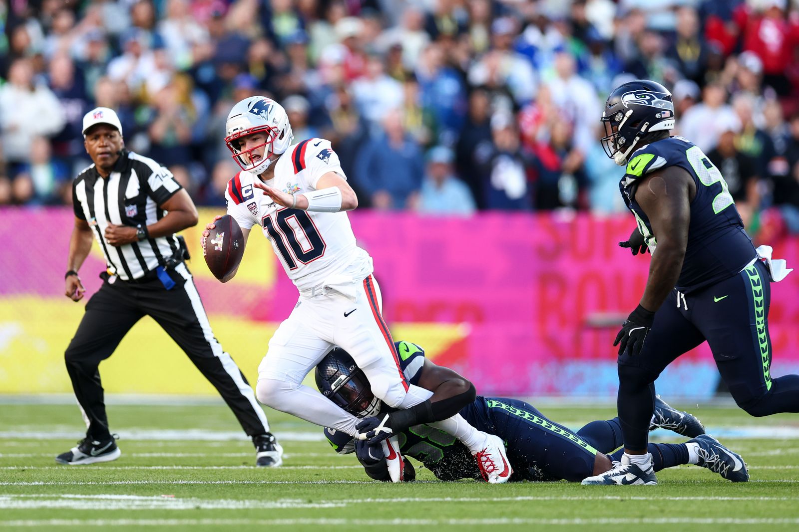 SANTA CLARA CALIFORNIA FEBRUARY 8 Seattle Seahawks linebacker Derick Hall gets the sack on New England Patriots...