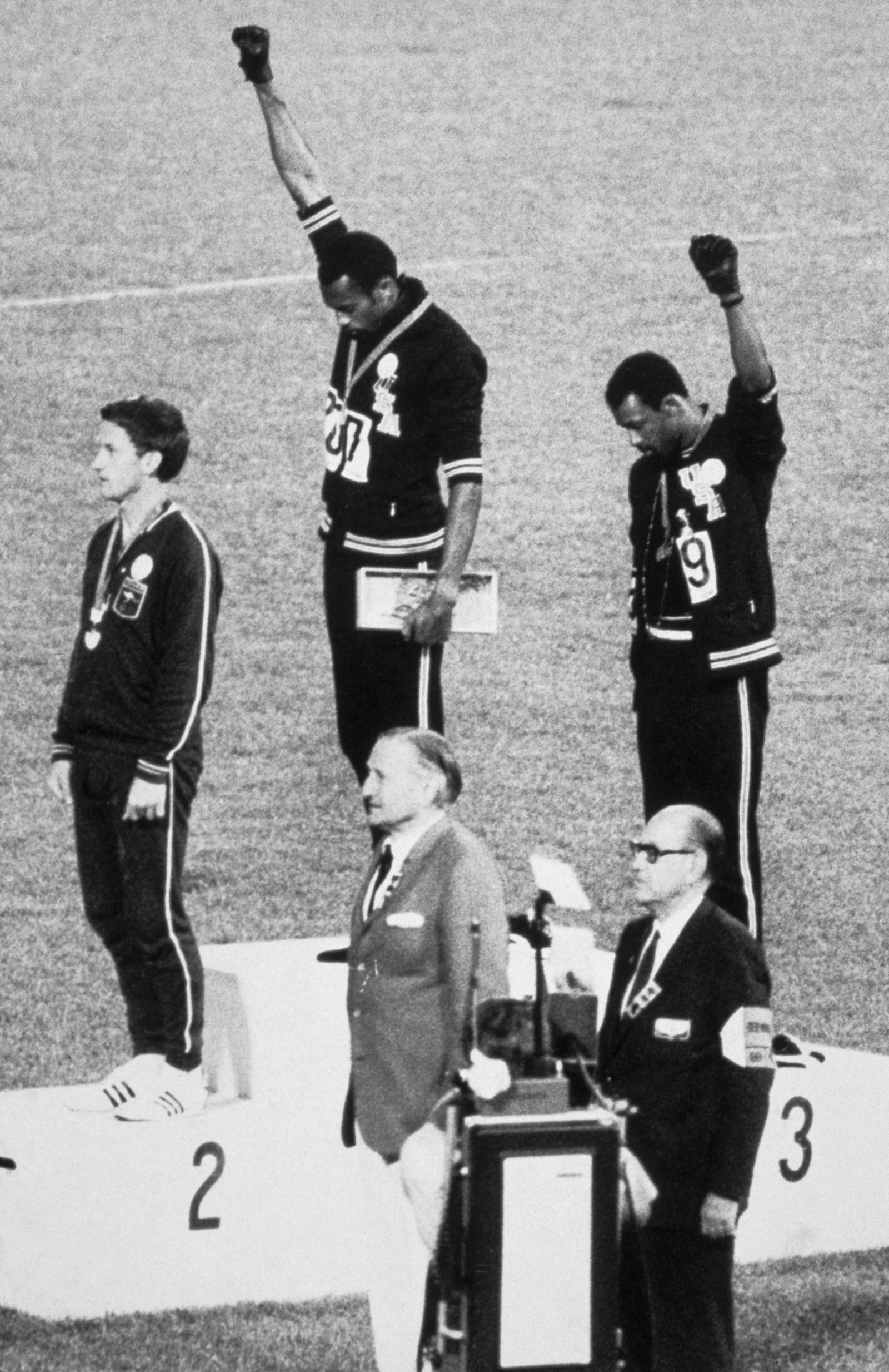 During the award presentation for the Men’s 200meter event final at the 1968 Summer Olympics American athletes gold...