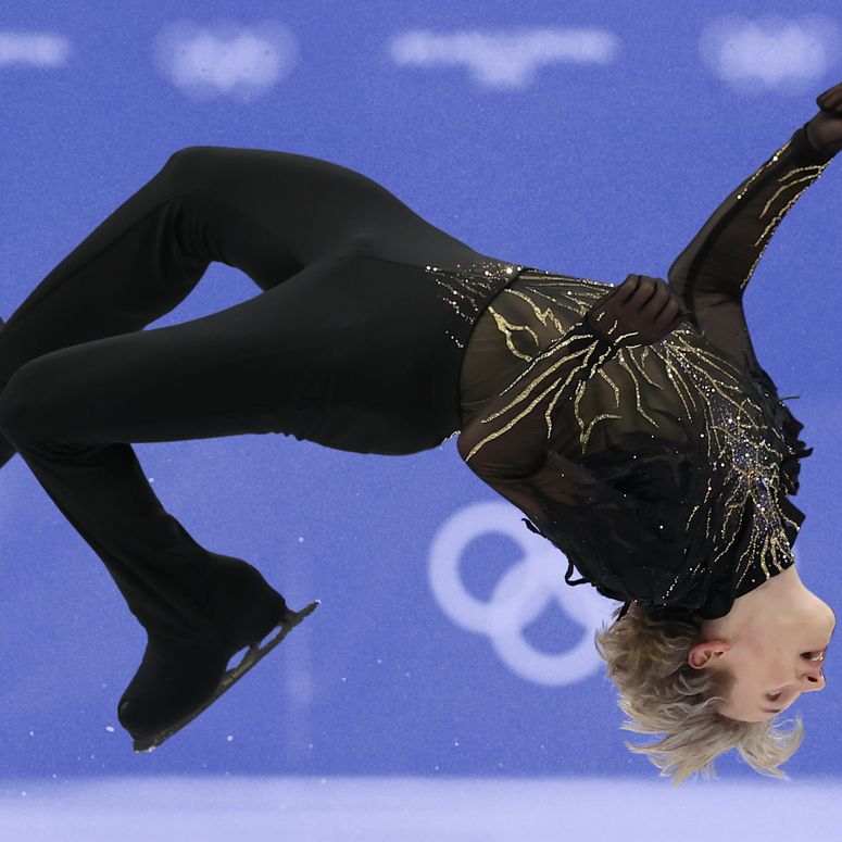 Figure skater Ilia Malin doing a backflip on ice at the 2026 Winter Olympics