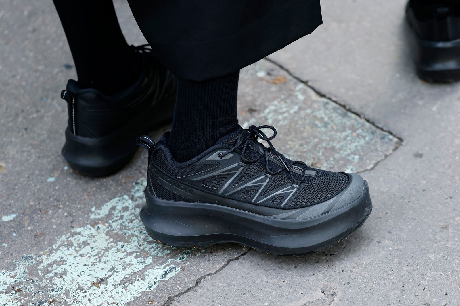 PARIS FRANCE JUNE 26 A guest wears black Salomon sneakers outside Issey Miyake during the Menswear SpringSummer 2026...