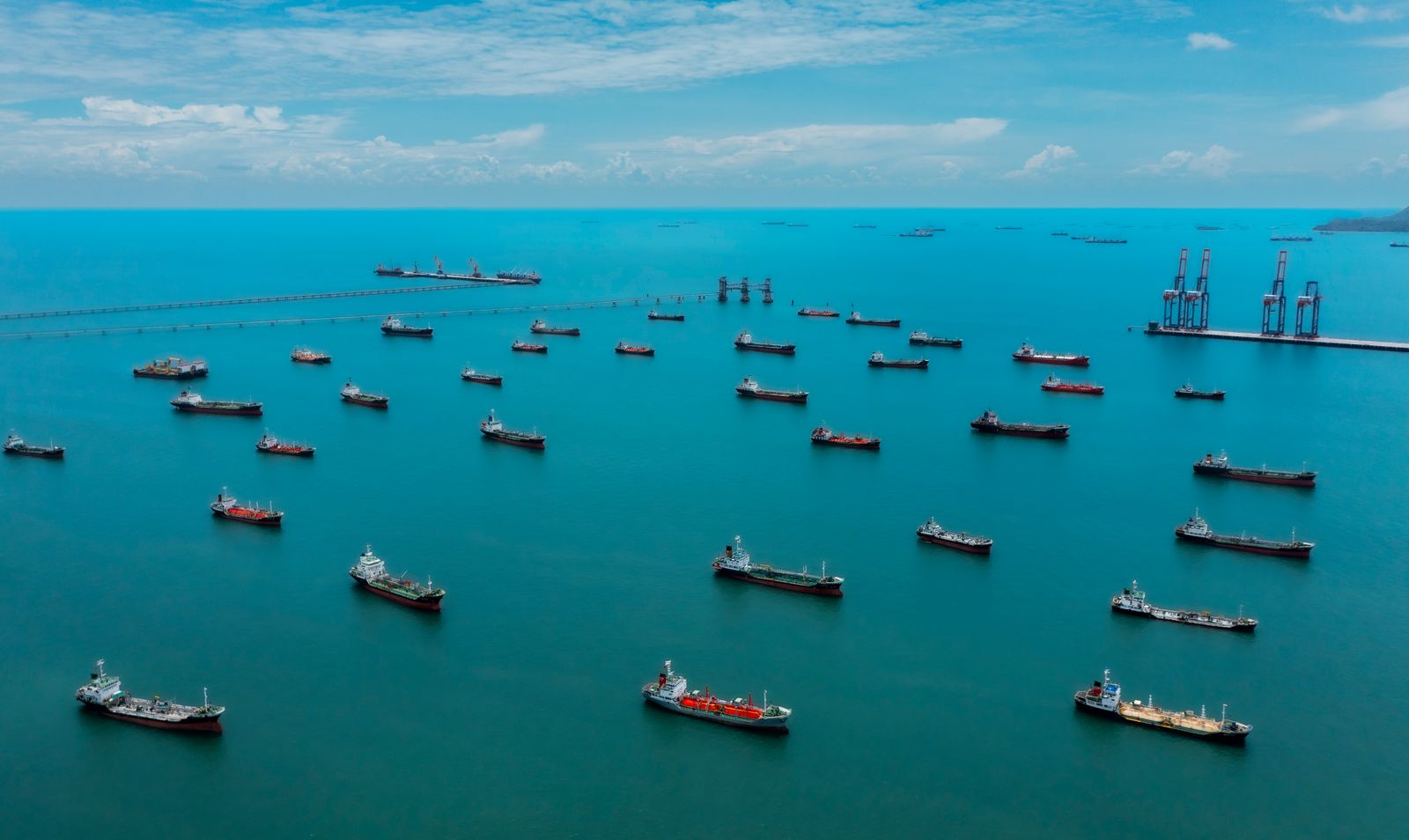Aerial view oil ship tanker waiting on the sea for load or unload oil from refinery. Business logistics import export...
